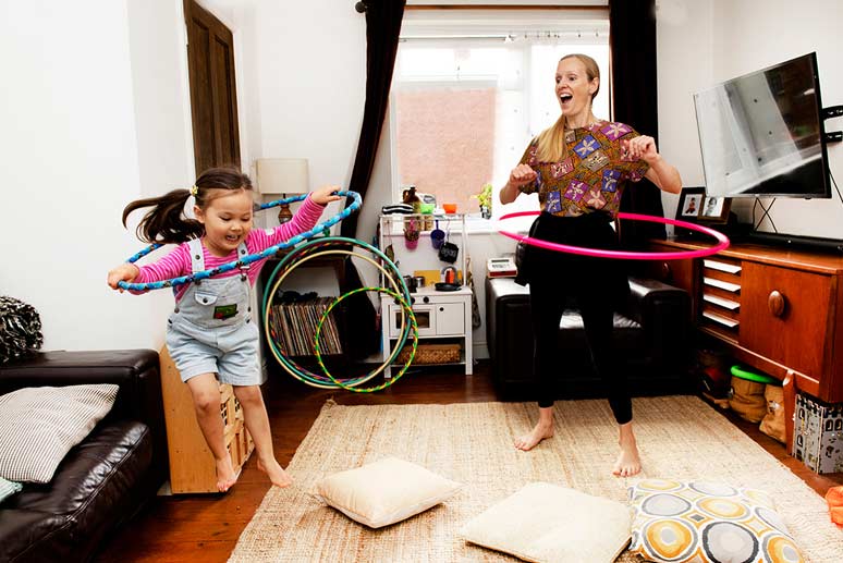 Debbie and her daughter hula-hooping together at home.