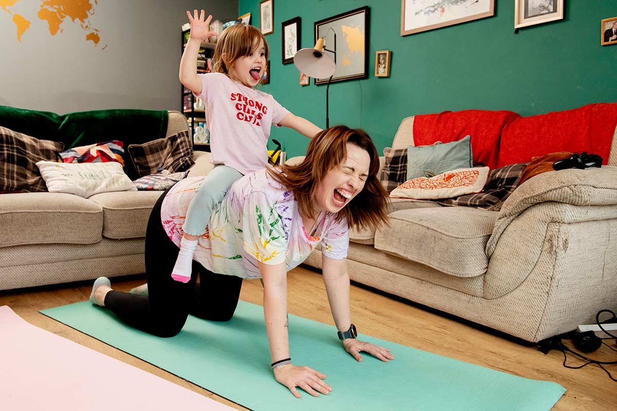 Kim and her daughter doing yoga at home.
